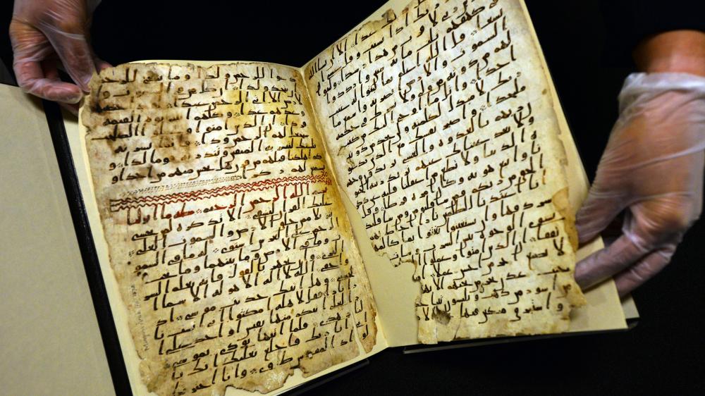 Une conservatrice de l'université de Birmingham (Royaume-Uni) montre, le 22 juillet 2015, de très anciens fragments du Coran, retrouvés dans la bibliothèque de l'établissement. (PAUL ELLIS / AFP)